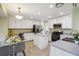 Spacious kitchen featuring white cabinetry, stainless steel appliances, and a cozy breakfast area at 15597 E Dorado Ave, Centennial, CO 80015