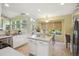 Bright kitchen with white cabinets, center island, and breakfast nook, offering a cozy space at 15597 E Dorado Ave, Centennial, CO 80015