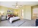 Spacious main bedroom with a ceiling fan, neutral tones, and access to the ensuite bathroom at 15597 E Dorado Ave, Centennial, CO 80015