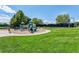 Community playground with slides, swings, and ample green space for recreational activities at 15597 E Dorado Ave, Centennial, CO 80015