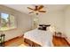 Cozy bedroom with hardwood floors, ceiling fan and large windows providing plenty of natural light at 1541 Poplar St, Denver, CO 80220