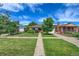 Well-manicured lawn and inviting landscaping in front of this charming single Gathering home at 1541 Poplar St, Denver, CO 80220