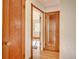 Hallway showcasing hardwood floors, vintage wood trim detail, and multiple entryways at 1541 Poplar St, Denver, CO 80220