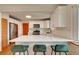 Bright kitchen featuring quartz countertops, stainless appliances, and breakfast bar at 1541 Poplar St, Denver, CO 80220