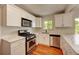 Modern kitchen with stainless steel appliances and pristine white cabinetry at 1541 Poplar St, Denver, CO 80220