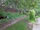 Landscaped backyard featuring a retaining wall, lush greenery, and mature trees, perfect for outdoor enjoyment at 13651 Silverton Dr, Broomfield, CO 80020