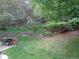 Picturesque backyard with a stone retaining wall, mature trees, and garden area perfect for landscaping at 13651 Silverton Dr, Broomfield, CO 80020