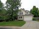 Attractive two-story home with a two-car garage, lush front lawn, and a mature tree for shade at 13651 Silverton Dr, Broomfield, CO 80020