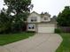 Traditional two-story home featuring a large driveway, attached two-car garage, and tidy landscaping at 13651 Silverton Dr, Broomfield, CO 80020