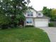 Charming two-story home with a well-manicured lawn, mature shade tree, and a two-car garage at 13651 Silverton Dr, Broomfield, CO 80020