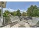 Relaxing outdoor balcony with comfortable seating and scenic views of the surrounding greenery at 3850 Vallejo St, Denver, CO 80211