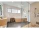 Modern bathroom featuring a luxurious tub and glass-enclosed shower at 3850 Vallejo St, Denver, CO 80211
