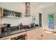 Modern kitchen with stainless steel appliances, light wood cabinetry, and a sleek, minimalist design at 3850 Vallejo St, Denver, CO 80211