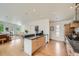 Open-concept kitchen with a bar, stainless steel appliances, and seamless flow into the living area at 3850 Vallejo St, Denver, CO 80211