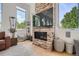 Living room with a stone fireplace and a view of the surrounding trees at 3850 Vallejo St, Denver, CO 80211