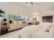 Bright main bedroom with a ceiling fan, large window, and open ensuite bathroom at 3850 Vallejo St, Denver, CO 80211