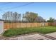 Landscaped backyard featuring a well-maintained lawn, tall privacy fence, and a tiled patio area for outdoor enjoyment at 1860 W Crestline Dr, Littleton, CO 80120