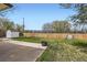 Fenced backyard with lush lawn, shed, concrete patio, and a metal fire pit, ideal for relaxing and entertaining at 1860 W Crestline Dr, Littleton, CO 80120