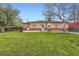 Expansive backyard with mature trees, green lawn, and a cozy patio area perfect for outdoor gatherings at 1860 W Crestline Dr, Littleton, CO 80120