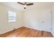 This bedroom has hardwood floors, a window, and a ceiling fan at 1860 W Crestline Dr, Littleton, CO 80120
