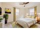 A bedroom features a ceiling fan, two windows, and an accent rug at 1860 W Crestline Dr, Littleton, CO 80120