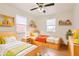 Cozy bedroom featuring two twin beds, wood floors, and ample natural light from two windows at 1860 W Crestline Dr, Littleton, CO 80120