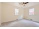 A bedroom features carpeted floors, a ceiling fan, and two windows at 1860 W Crestline Dr, Littleton, CO 80120