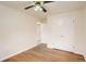A bedroom featuring hardwood floors, a ceiling fan, and a double door closet at 1860 W Crestline Dr, Littleton, CO 80120