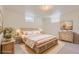 A bedroom with a decorative bed frame, bedside tables, and soft, floral bedding at 1860 W Crestline Dr, Littleton, CO 80120
