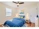 A bedroom features wood floors, white trim, a ceiling fan, and an accent wall at 1860 W Crestline Dr, Littleton, CO 80120