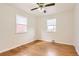 A bedroom featuring wood floors, two windows, and a ceiling fan at 1860 W Crestline Dr, Littleton, CO 80120