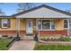 Inviting front porch with decorative columns leads to the home's front door and large picture window at 1860 W Crestline Dr, Littleton, CO 80120
