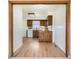 View of the kitchen from the dining room, featuring warm wood cabinets and bright countertops at 1860 W Crestline Dr, Littleton, CO 80120