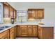 This kitchen offers ample cabinet space with stylish hardware and a view through the window at 1860 W Crestline Dr, Littleton, CO 80120
