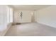 Bright, carpeted living room with large windows, a decorative shelf and a hallway entrance at 1860 W Crestline Dr, Littleton, CO 80120