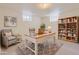 A basement office area with a gray chair, rug, desk, and shelving at 1860 W Crestline Dr, Littleton, CO 80120