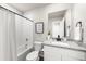 Bright bathroom featuring a shower-tub combo, granite vanity top and a modern framed mirror at 2489 Alto St, Fort Lupton, CO 80621