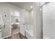 Bright bathroom features a soaking tub with a shower, a toilet, and entry to the bedroom at 2489 Alto St, Fort Lupton, CO 80621