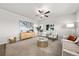 Bright living room featuring neutral tones and a ceiling fan at 2489 Alto St, Fort Lupton, CO 80621