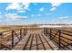 A picturesque view from a wooden bridge overlooking a scenic landscape and distant houses at 2489 Alto St, Fort Lupton, CO 80621