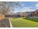 Backyard featuring synthetic grass, garden beds, and privacy fencing at 7120 Galapago St, Denver, CO 80221