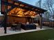 Inviting backyard patio featuring a dining area, lounge seating, and outdoor lighting at 7120 Galapago St, Denver, CO 80221