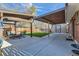 Expansive backyard with dual covered patios, outdoor seating, and manicured lawn at 7120 Galapago St, Denver, CO 80221