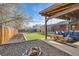 Backyard with an outdoor seating area, a swing, firepit and synthetic grass at 7120 Galapago St, Denver, CO 80221