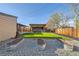 Large backyard featuring artificial turf, a gazebo, and several lounge areas at 7120 Galapago St, Denver, CO 80221