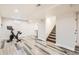 This basement features wood-look floors and stairs to the upper level at 7120 Galapago St, Denver, CO 80221