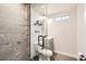 Modern bathroom featuring a glass shower, floating vanity, and tasteful fixtures at 7120 Galapago St, Denver, CO 80221
