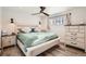 This bedroom features neutral tones, wood-look floors, and a ceiling fan at 7120 Galapago St, Denver, CO 80221