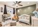 Cozy Bedroom design featuring a crib and olive green accent wall at 7120 Galapago St, Denver, CO 80221