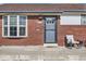 Close up of the front door with chairs outside and well maintained facade at 7120 Galapago St, Denver, CO 80221